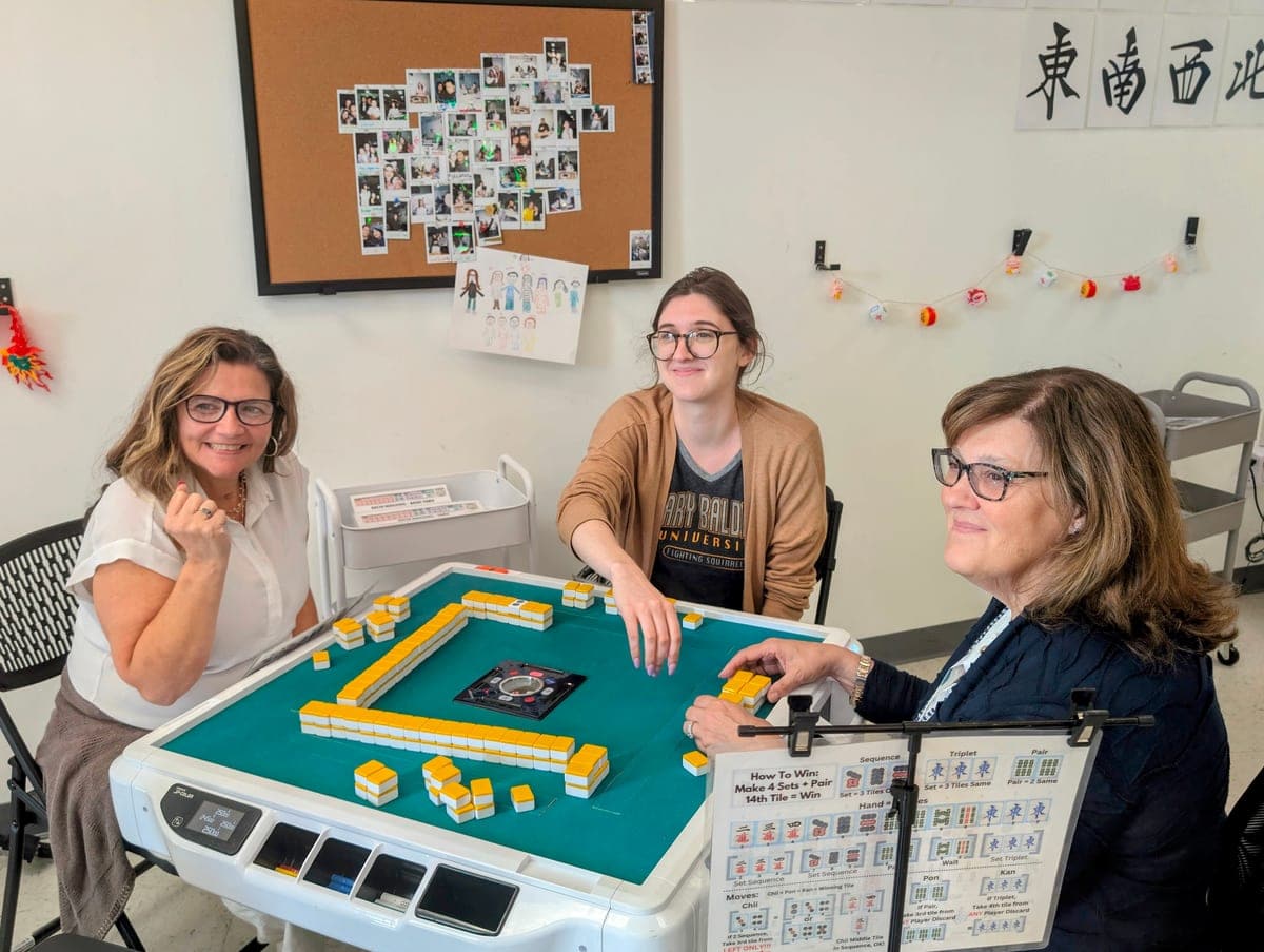 Players seated around a mahjong table at Setting Sun Virginia Beach